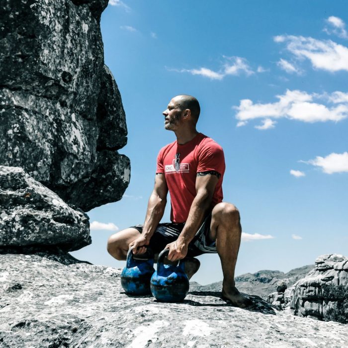 Focused athlete working through a tough kettlebell training set