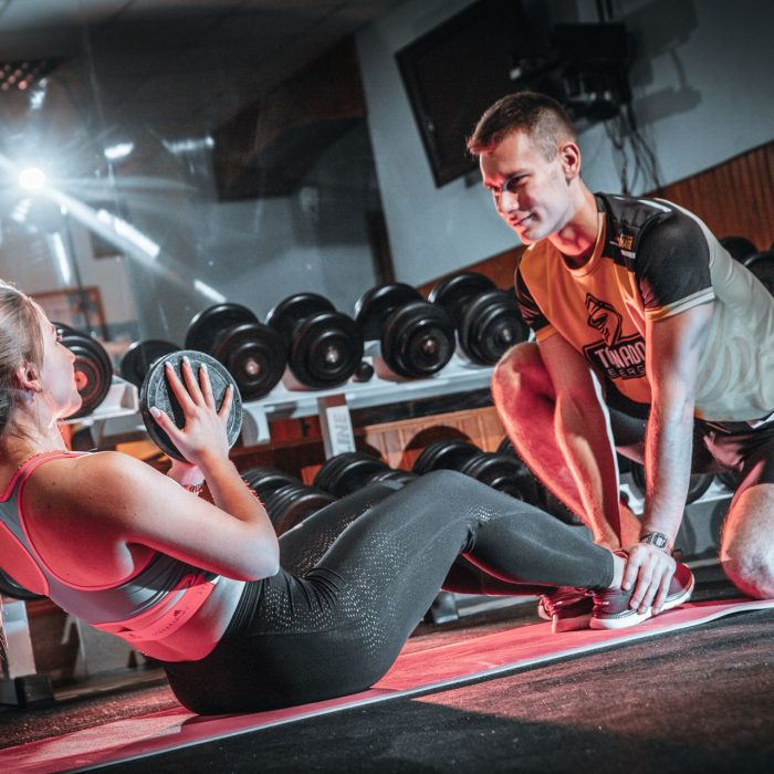 Coach and member discussing a fitness plan in the gym