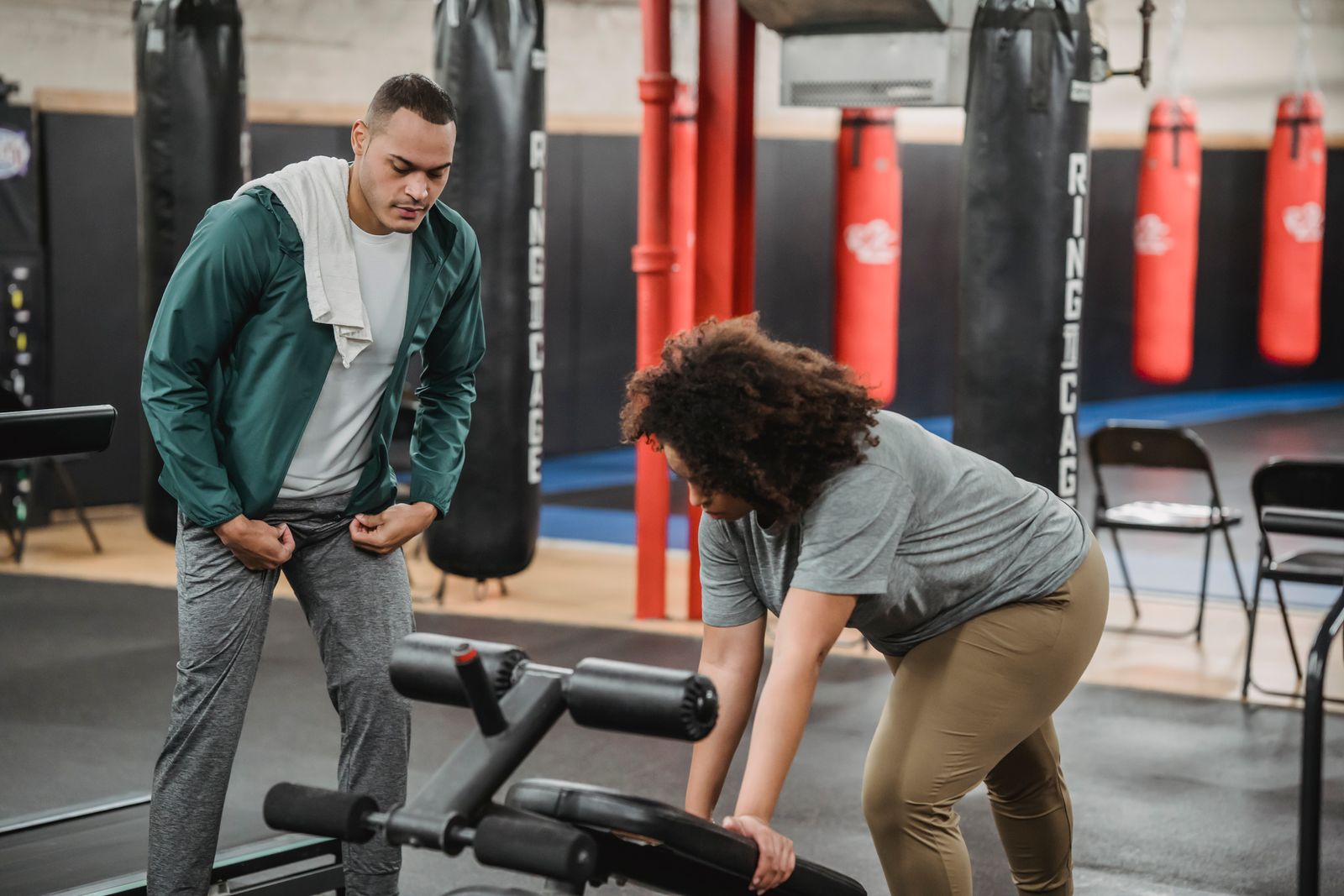 Trainer guiding a member with correct technique