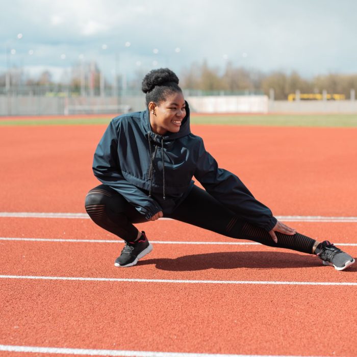 Athlete stretching to warm up and prevent injury